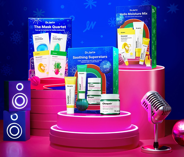 Pink podiums that features Dr Jart + skincare products, with a microphone positioned to the right and an amplifier to the left.